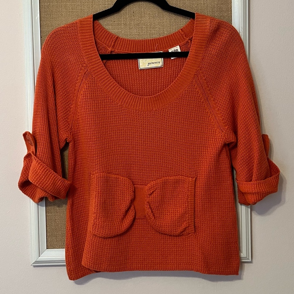Scoop neck orange sweater with bow pockets. Size S. From Anthropologie.